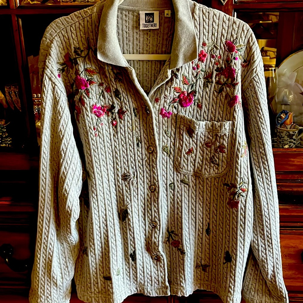 Beautiful soft gray knit sweater with pink floral appliqués.